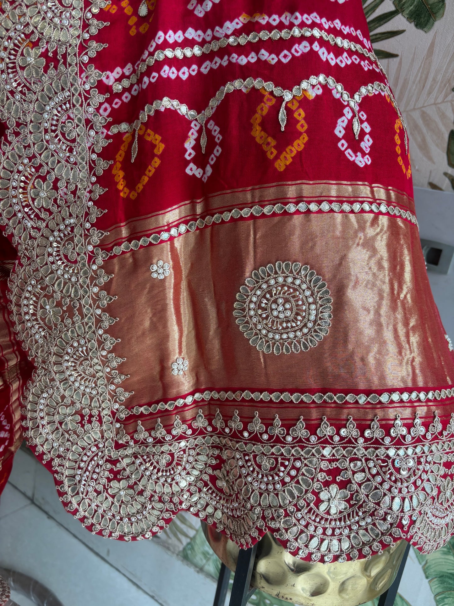 Draped in tradition, adorned with elegance. A timeless Red Ghatchola Saree for your grand celebrations.