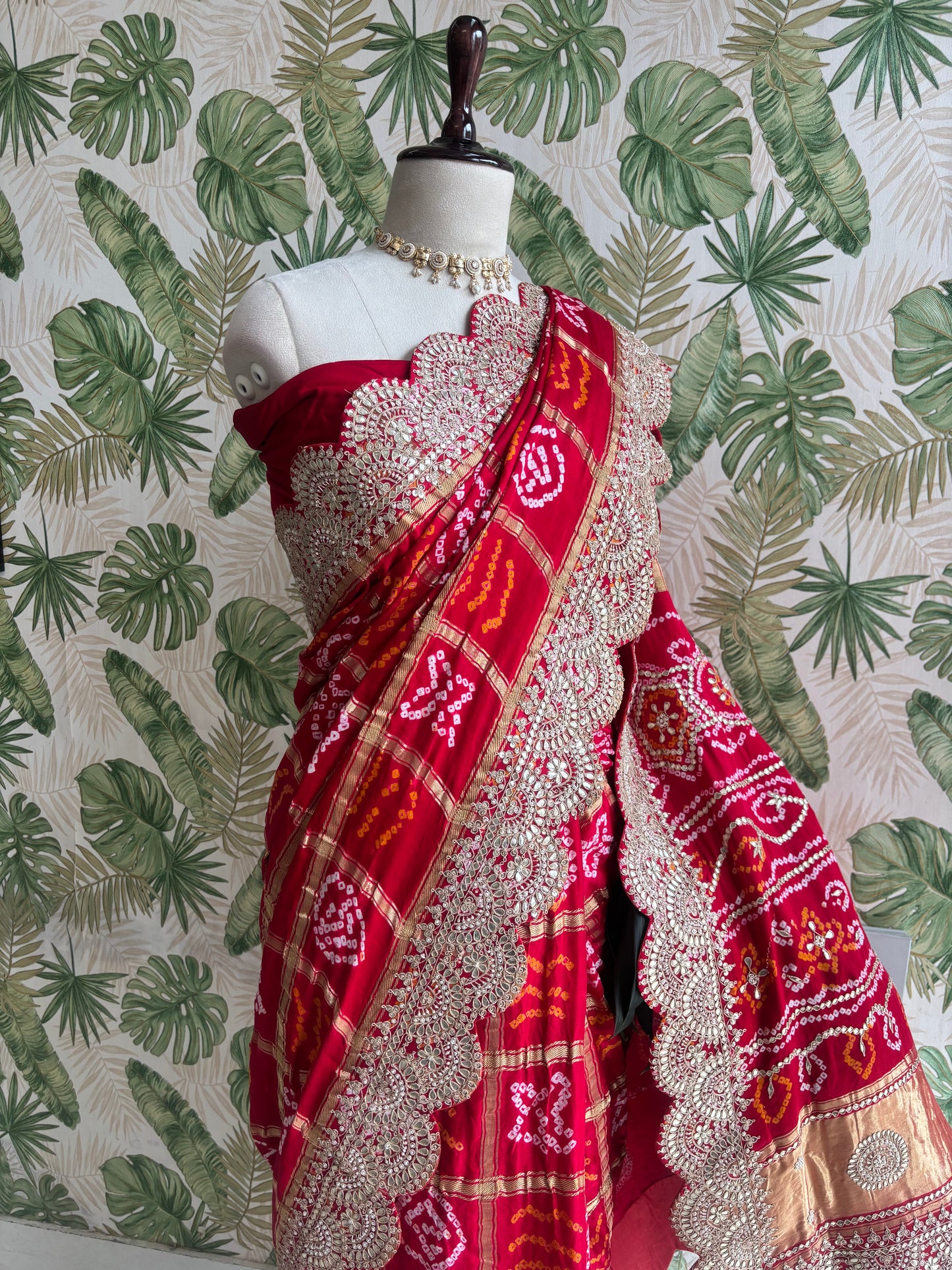 Draped in tradition, adorned with elegance. A timeless Red Ghatchola Saree for your grand celebrations.