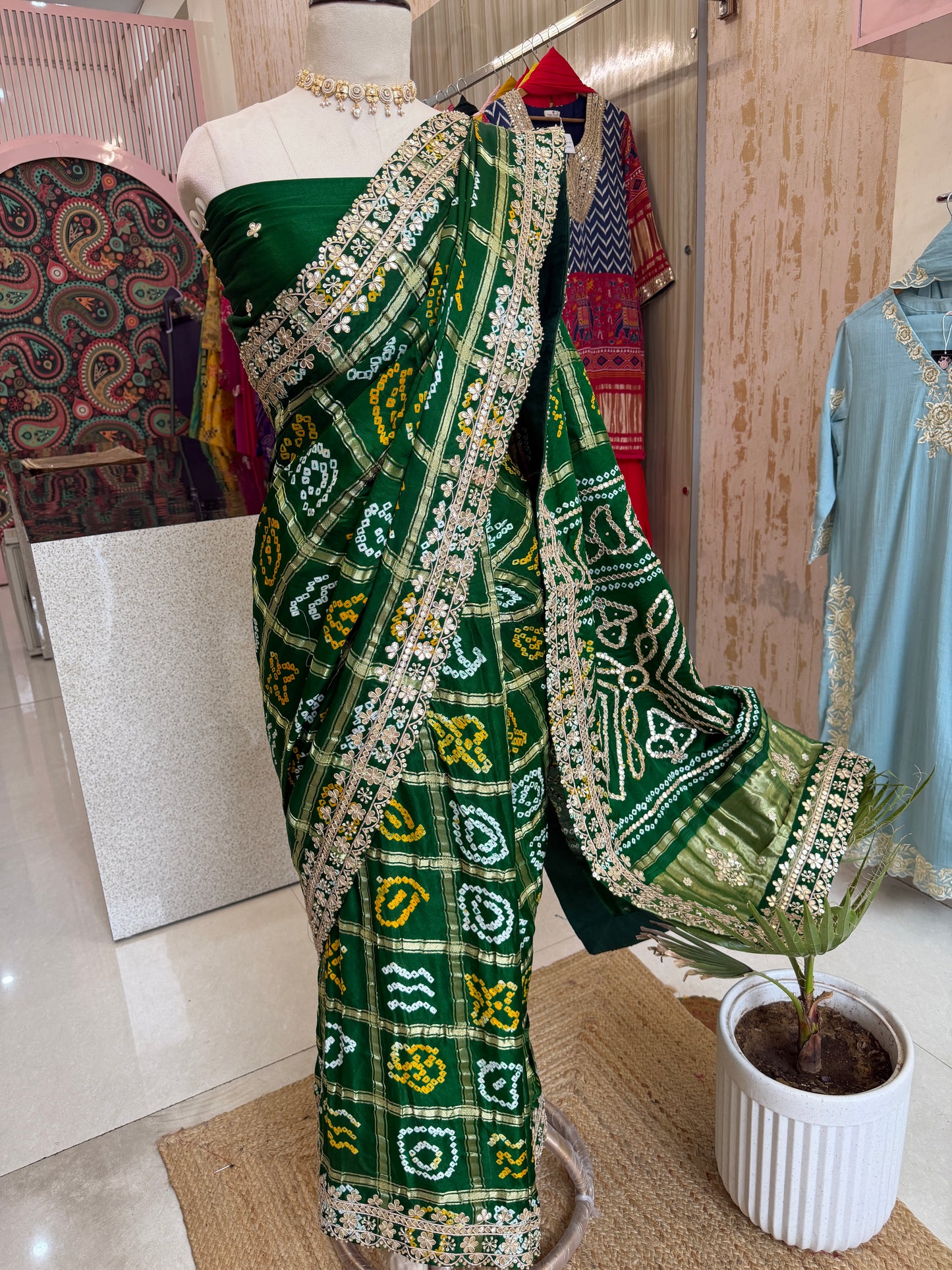 Bottel green elegance woven in every drape. 💚✨ This exquisite Gajji Silk Bandhej Saree with delicate gota patti work